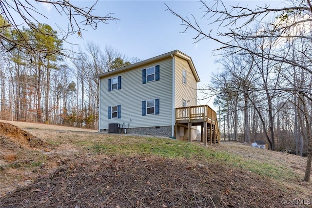 view of side of property featuring stairs, a deck, and central AC