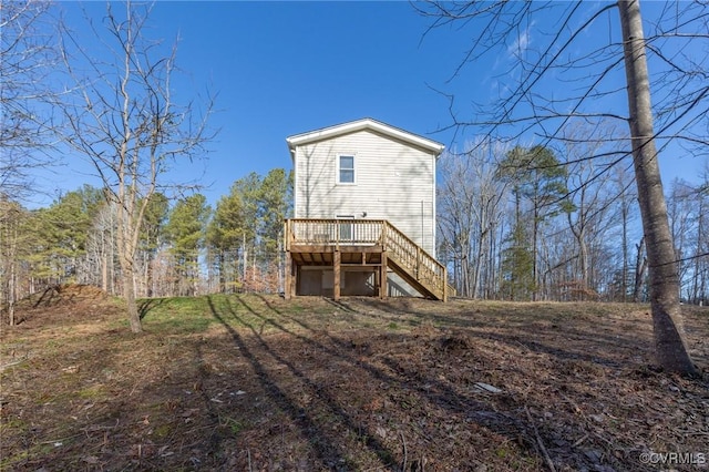 back of property with a wooden deck and stairway