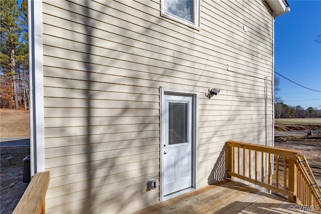view of exterior entry with a deck
