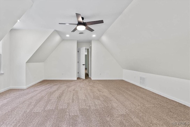 additional living space with carpet flooring, a ceiling fan, baseboards, lofted ceiling, and visible vents