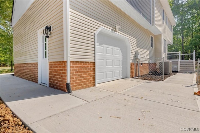 6013 Linden Ln, Disputanta, VA 23842 - garage featuring central air condition unit and concrete driveway