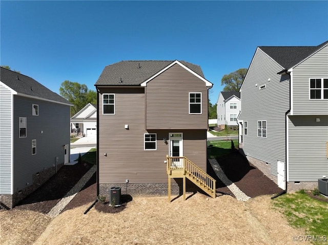 back of house featuring a residential view and central air condition unit