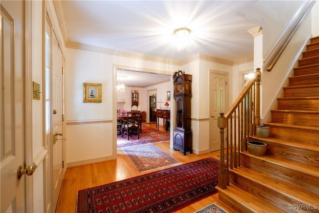 entryway featuring stairway, baseboards, and light wood finished floors