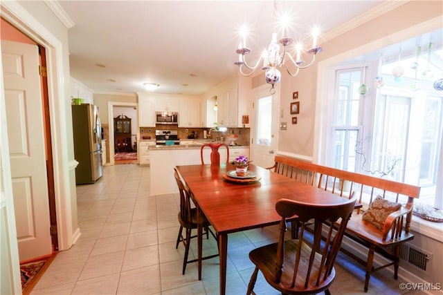 dining room featuring visible vents, ornamental molding, light tile patterned flooring, and a chandelier