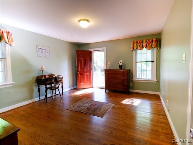 foyer entrance featuring baseboards and wood finished floors