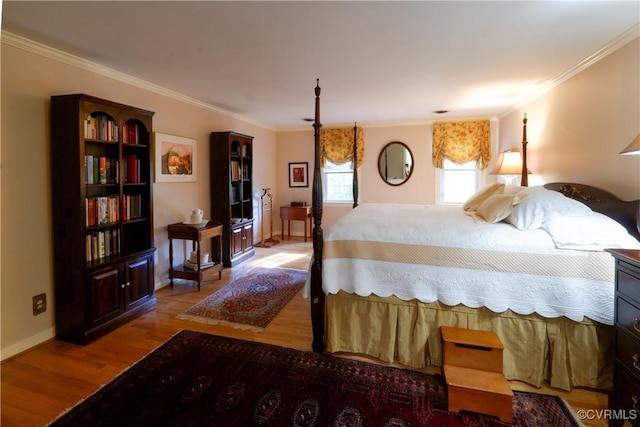 bedroom featuring crown molding, baseboards, and wood finished floors