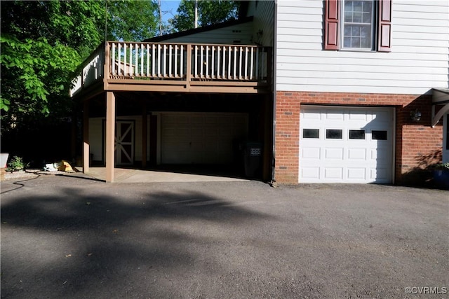 view of property exterior featuring brick siding and a garage
