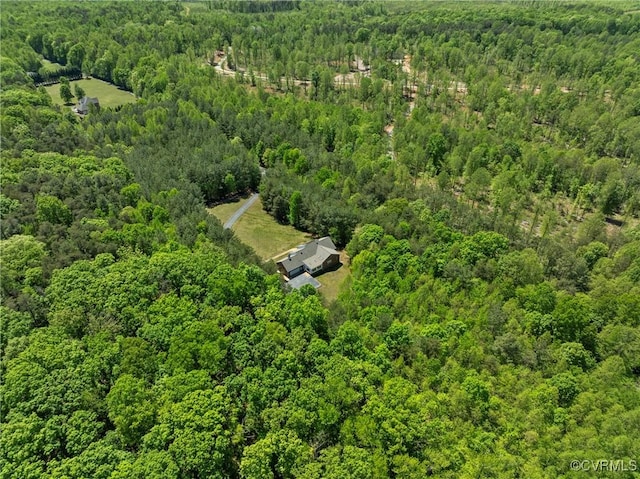 birds eye view of property featuring a wooded view