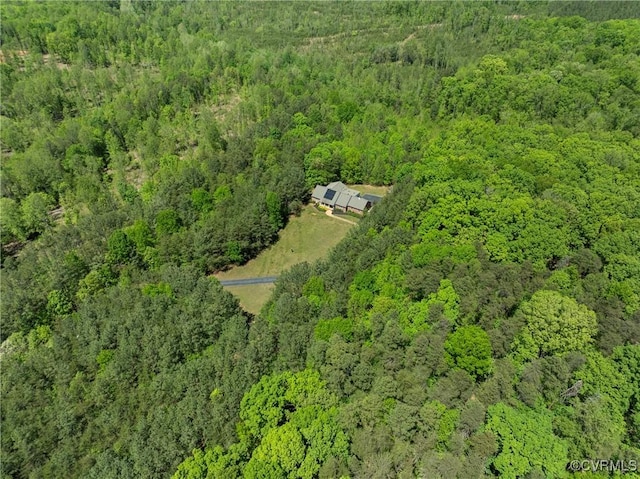 drone / aerial view featuring a forest view