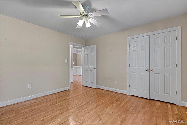 unfurnished bedroom featuring light wood-type flooring, a ceiling fan, baseboards, and a closet