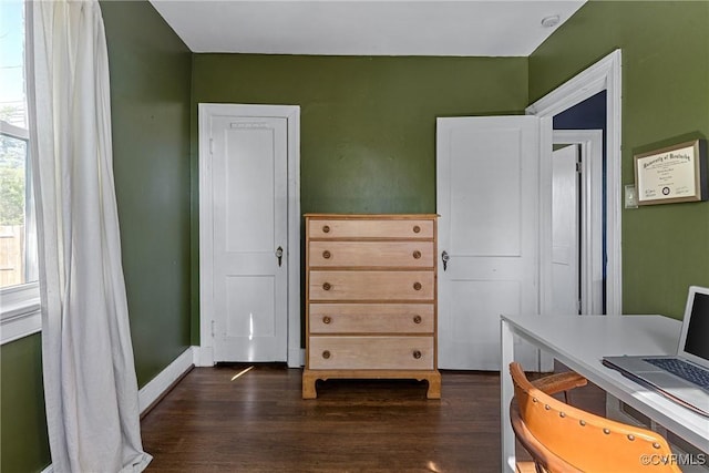 office space featuring dark wood-style flooring and baseboards