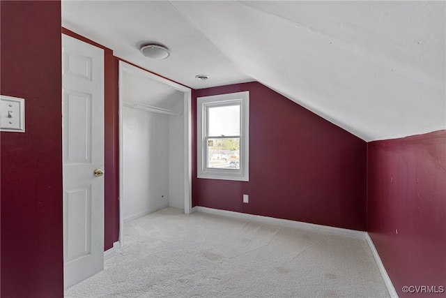 bonus room featuring baseboards, lofted ceiling, and carpet floors