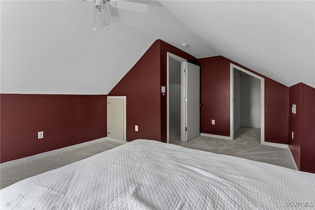 carpeted bedroom with baseboards, vaulted ceiling, and ceiling fan