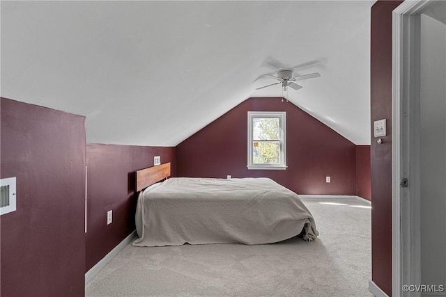carpeted bedroom with vaulted ceiling, baseboards, and a ceiling fan