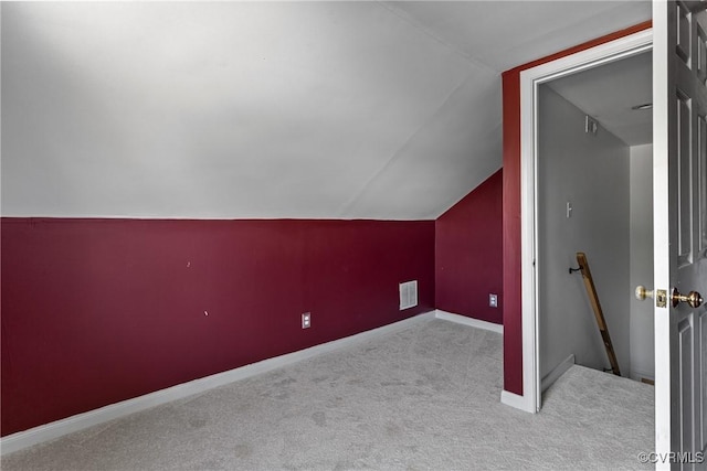bonus room with visible vents, baseboards, lofted ceiling, and carpet floors
