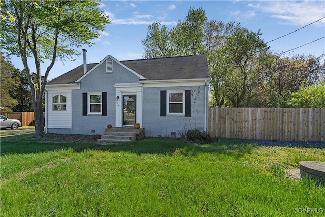 bungalow-style house featuring crawl space, fence, a front lawn, and brick siding