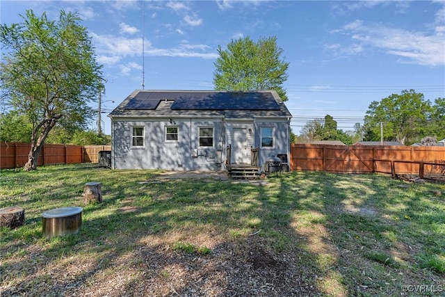 view of outbuilding with a fenced backyard and solar panels