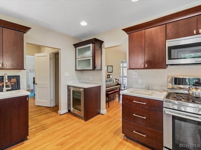 1612 Brookland Pkwy, Richmond, VA 23227 - kitchen featuring appliances with stainless steel finishes, light wood finished floors, wine cooler, light countertops, and recessed lighting