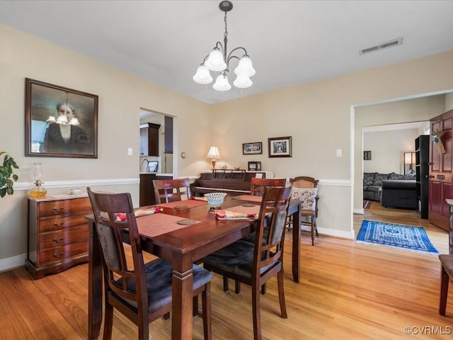 1612 Brookland Pkwy, Richmond, VA 23227 - dining space with a chandelier, light wood-style floors, and baseboards