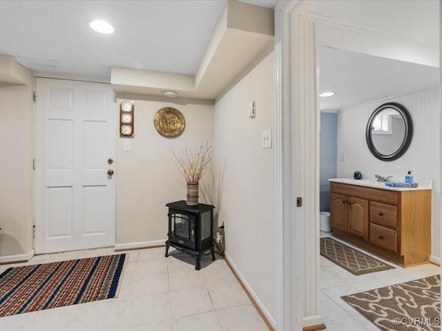 1612 Brookland Pkwy, Richmond, VA 23227 - foyer entrance featuring light tile patterned floors, a wood stove, and baseboards
