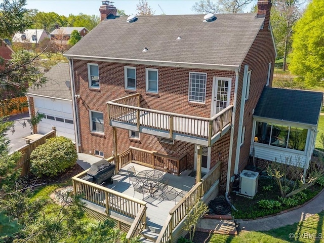 1612 Brookland Pkwy, Richmond, VA 23227 - rear view of property with a chimney, central AC, a garage, and a deck