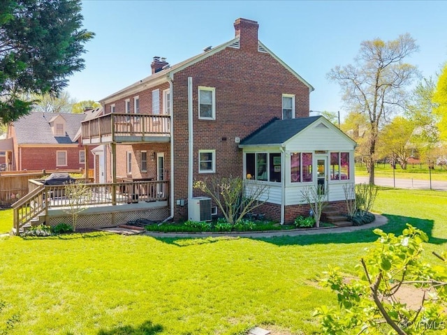 1612 Brookland Pkwy, Richmond, VA 23227 - back of property with a chimney, a deck, a sunroom, and a lawn