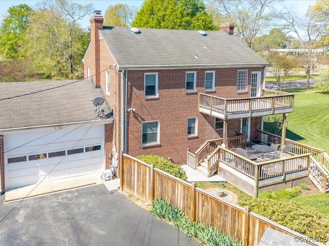 1612 Brookland Pkwy, Richmond, VA 23227 - rear view of property featuring a chimney, a deck, and brick siding