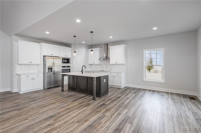 26437 Pennfields Dr, Orange, VA 22960 - kitchen with appliances with stainless steel finishes, wall chimney exhaust hood, light countertops, wood finished floors, and tasteful backsplash