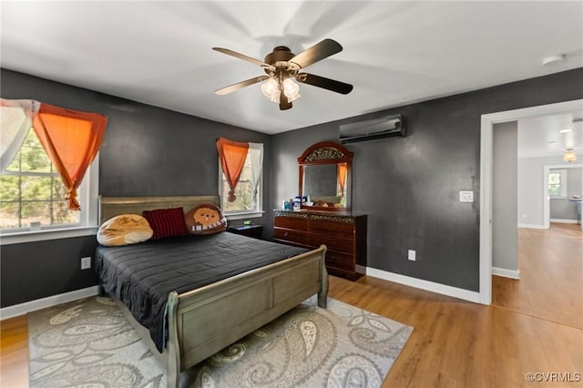 1474 Welsh Tract Rd, Charlotte Courthouse, VA 23923 - bedroom featuring a wall unit AC, wood finished floors, and ceiling fan