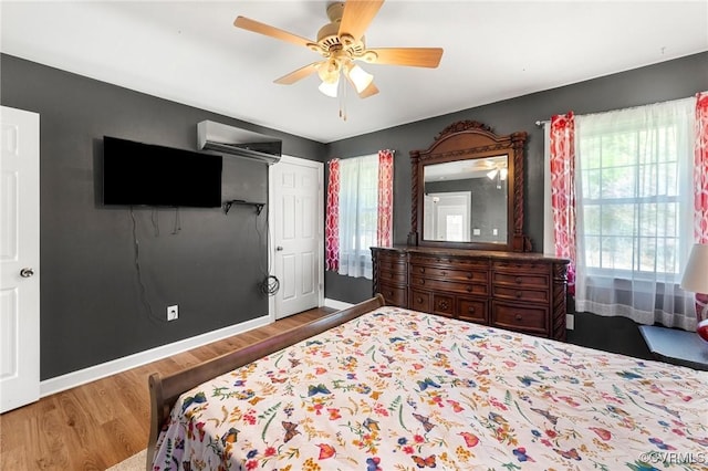 1474 Welsh Tract Rd, Charlotte Courthouse, VA 23923 - bedroom with wood finished floors, ceiling fan, and a wall mounted air conditioner