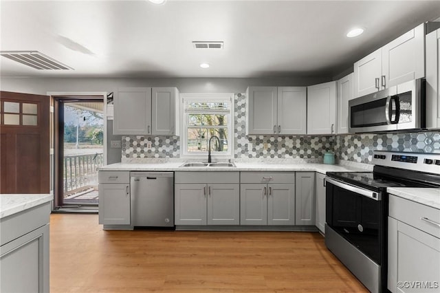 1474 Welsh Tract Rd, Charlotte Courthouse, VA 23923 - kitchen featuring stainless steel appliances, gray cabinetry, tasteful backsplash, light wood-style floors, and recessed lighting