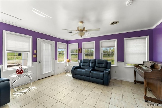 1474 Welsh Tract Rd, Charlotte Courthouse, VA 23923 - living area featuring light tile patterned flooring, plenty of natural light, ornamental molding, a ceiling fan, and a wainscoted wall