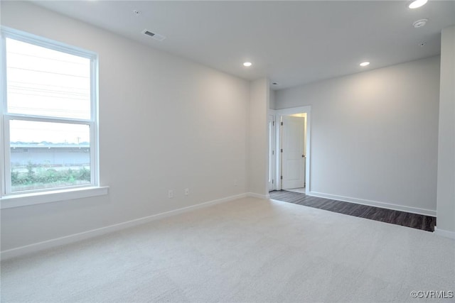empty room with recessed lighting, baseboards, visible vents, and carpet