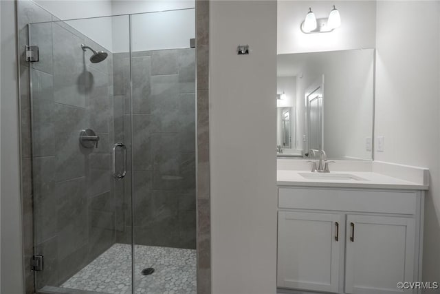 bathroom with a shower stall and vanity
