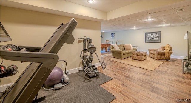 workout room featuring baseboards, recessed lighting, wood finished floors, and visible vents