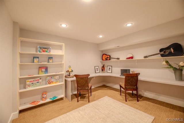 recreation room with recessed lighting, light colored carpet, and built in desk