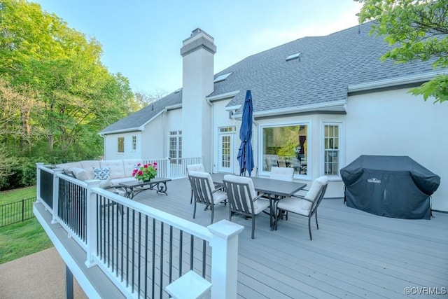 deck with an outdoor living space, outdoor dining space, and a grill
