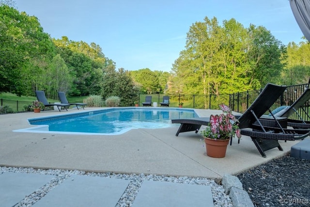 view of swimming pool featuring a fenced in pool, fence, and a patio area