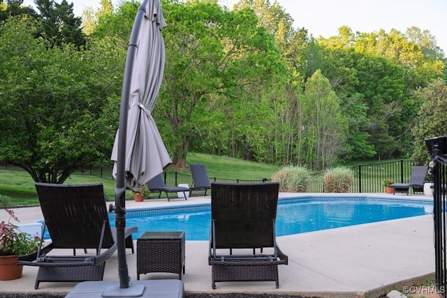 view of swimming pool featuring fence, a fenced in pool, and a patio area