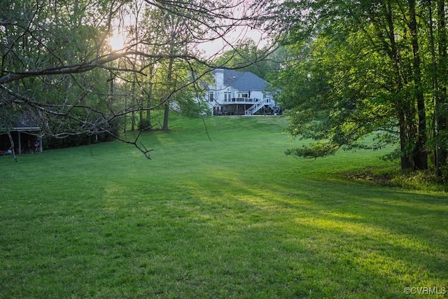 view of yard featuring stairs and a deck