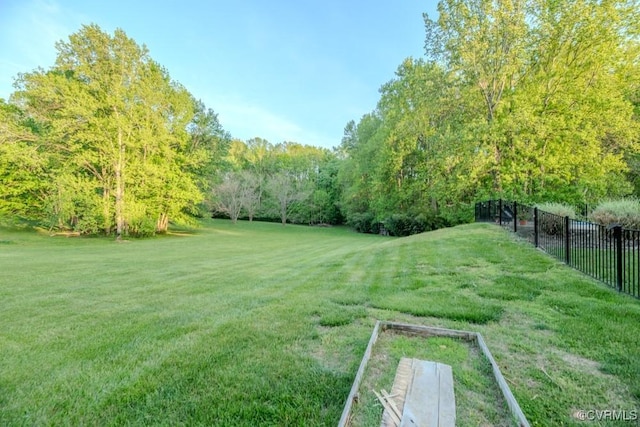 view of yard featuring a view of trees and fence