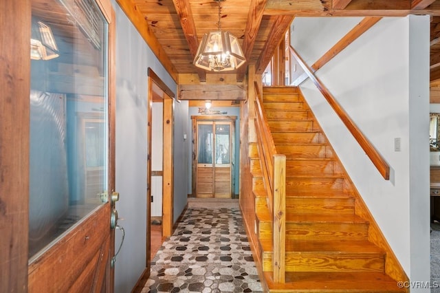 stairway with wooden ceiling and a notable chandelier