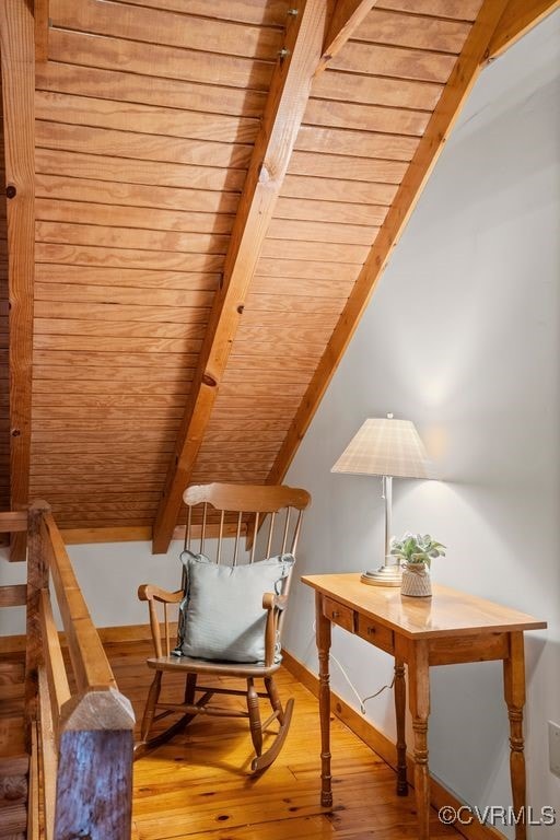 sitting room featuring vaulted ceiling with beams, wooden ceiling, wood finished floors, and baseboards