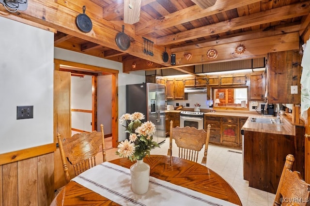 dining room featuring beamed ceiling and wood ceiling