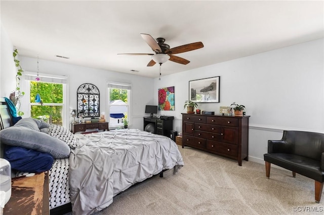 bedroom with light colored carpet, ceiling fan, visible vents, and access to exterior