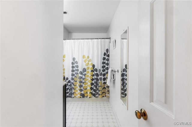 bathroom with tile patterned floors and a shower with shower curtain