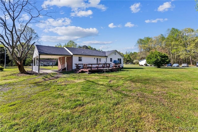 view of yard featuring a wooden deck and a carport