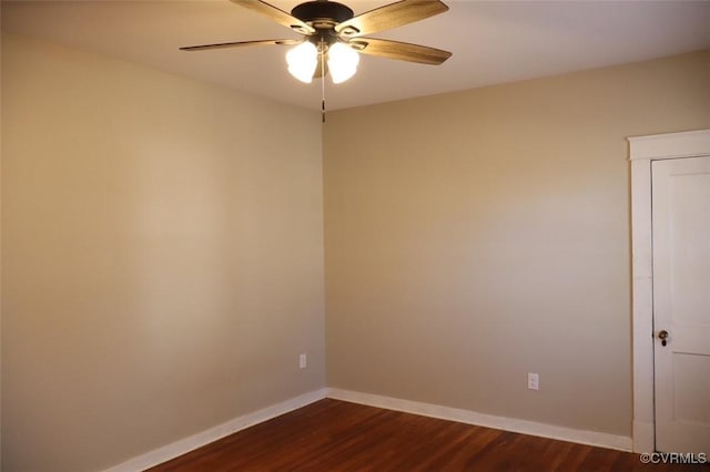 empty room featuring dark wood-style floors, baseboards, and a ceiling fan