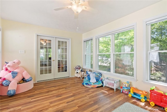 game room featuring ceiling fan, french doors, and wood finished floors