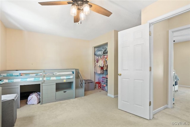 carpeted bedroom with baseboards, ceiling fan, and a closet